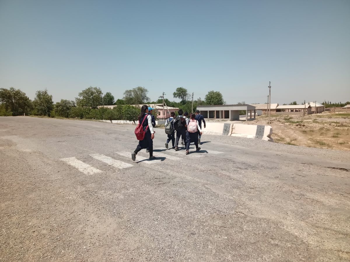 Children walk to school in a neighboring village. Photo: CABAR.asia